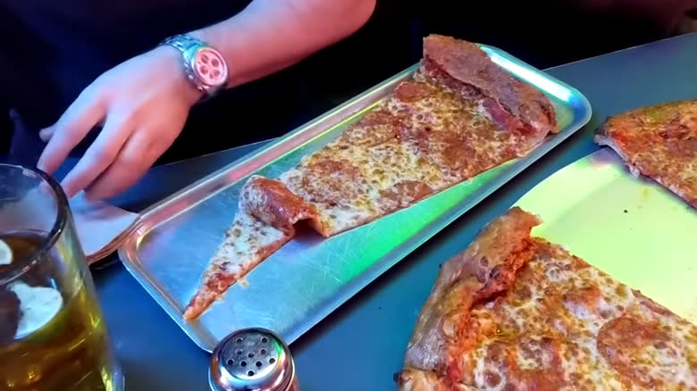 Huge pizza slice with pizza
