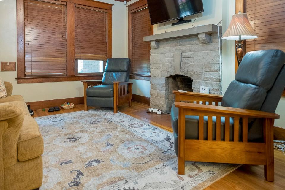 The living room is furnished for comfort. The original wood tones have been present since the home’s original construction.