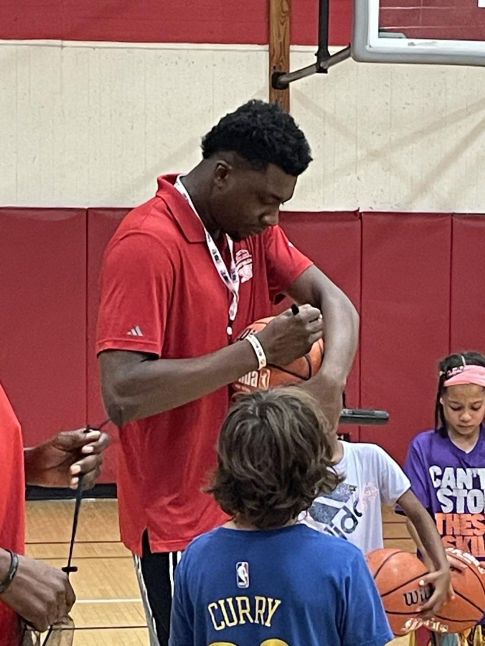 Thomas Bryant autographs basketball for kids who were named Campers of the Week at his annual Thomas Bryant Basketball Camp. The Rochester native won an NBA championship with the Denver Nuggets in June, and will play for the Miami Heat this upcoming season.