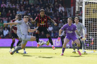 Bournemouth's Justin Kluivert, centre, and Everton's James Tarkowski, left, challenge for the ball during the English Premier League soccer match between AFC Bournemouth vs Everton at the Vitality Stadium, Bournemouth, England, Saturday, March 30, 2024. (Andrew Matthews/PA via AP)