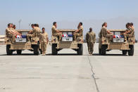 BAGRAM, AFGHANISTAN - AUGUST 21: In this handout image provided by The New Zealand Defence Force, New Zealand soldiers pay their respect during a ramp ceremony for Corporal Luke Tamatea, Lance Corporal Jacinda Baker and Private Richard Harris at Bagram Air Base on August 21, 2012 in Bagram, Afghanistan. The three New Zealand soldiers where killed in Afghanistan on August 19 after their vehicle was hit by a roadside bomb. (Photo by The New Zealand Defence Force via Getty Images)