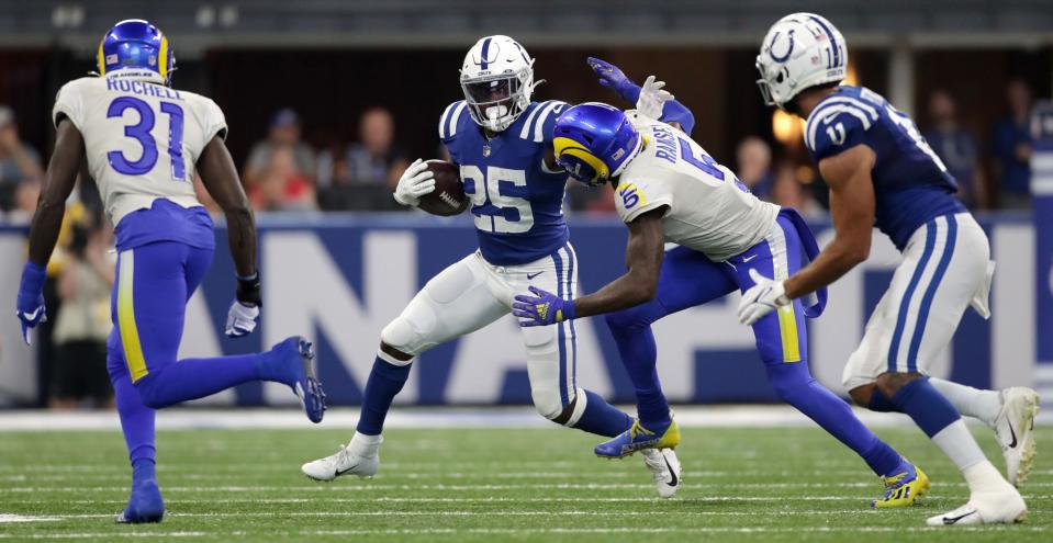 Indianapolis Colts running back Marlon Mack (25) works to move the ball past Los Angeles Rams cornerback Jalen Ramsey (5) on Sunday, Sept. 19, 2021, during a game against the Los Angeles Rams at Lucas Oil Stadium in Indianapolis.