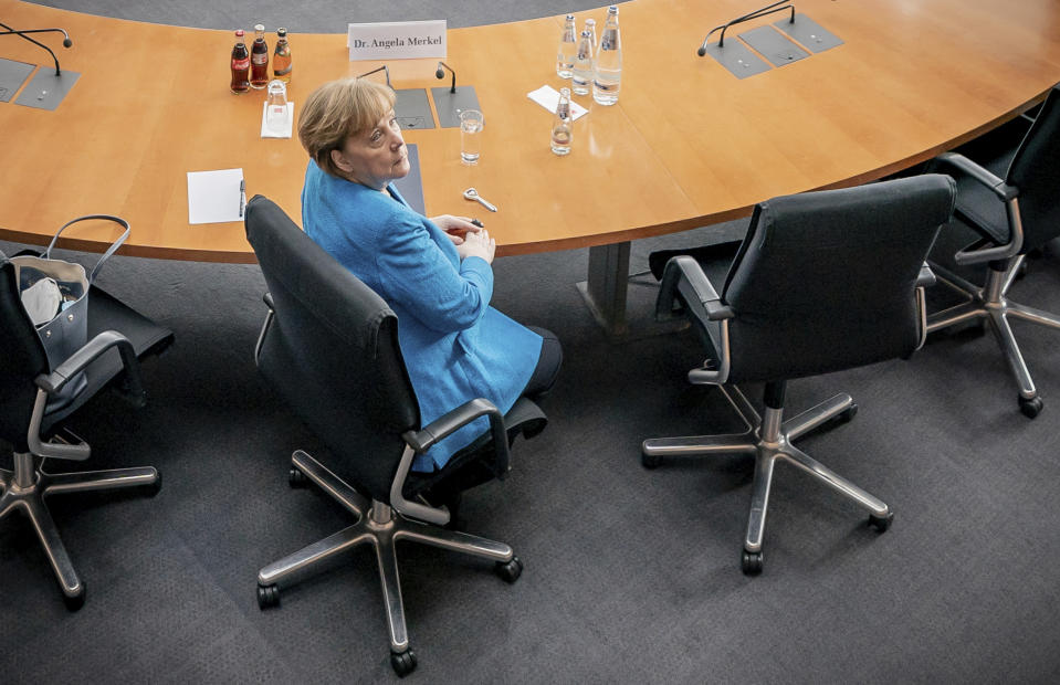 German Chancellor Angela Merkel arrives for the Wirecard investigation committee in Berlin, Germany, Friday, April 23, 2021. She has been summoned as a witness because she spoke up for Wirecard during a trip to China in September 2019. The 3rd Bundestag Investigative Committee is to investigate the conduct of the German government and the authorities under it in connection with the events surrounding the now insolvent financial services provider Wirecard. (Michael Kappeler/AP via Pool)