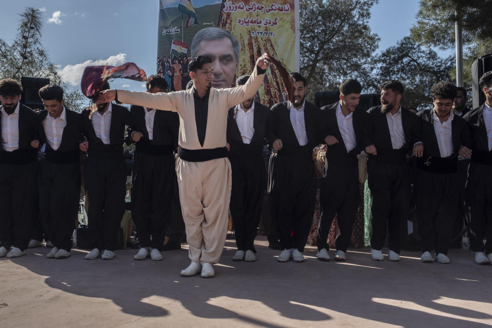 Iraqi Kurds celebrate Nowruz, a Persian New Year, in Sulaimaniyah, Iraq, Monday, March 20, 2023. The Kurdish in Iraq region won de facto self-rule in 1991 when the United States imposed a no-fly zone over it in response to Saddam's brutal repression of Kurdish uprisings. With American invasion 20 years ago much of Iraq fell into chaos, as occupying American forces fought an insurgency and as multiple political and sectarian communities vied to fill the power vacuum left in Baghdad. But the Kurds, seen as staunch allies of the Americans, strengthened their political position and courted foreign investments. (AP Photo/Hawre Khalid, Metrography)