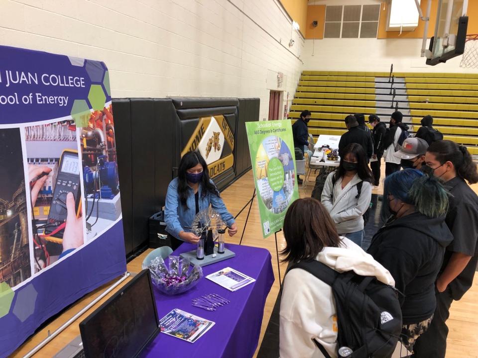 Students at Chinle High School in Chinle, Ariz., gather around a San Juan College School of Energy table to watch a demonstration during a recent STEM fair. The college participates in many such events across the region as part of its outreach efforts.