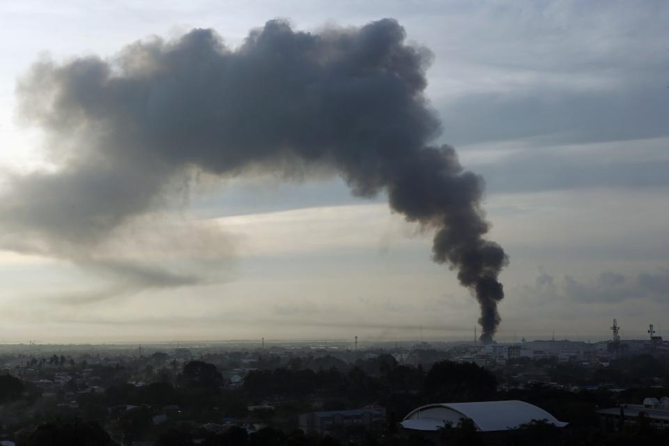 Smoke billows from burning houses in a residential district as firefight rages between government soldiers and Muslim rebels of Moro National Liberation Front (MNLF) in Zamboanga city in southern Philippines September 16, 2013. (REUTERS/Erik De Castro)