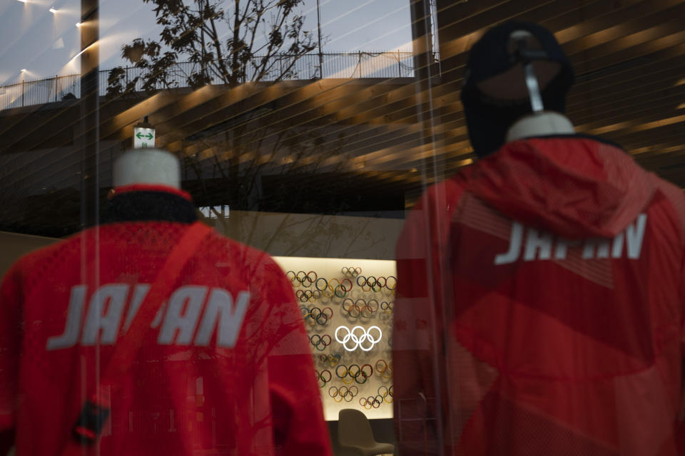 The Olympics rings made with various materials and Japan national team's uniforms are on display at Tokyo Olympic Museum, in Tokyo, Monday, March 23, 2020. The IOC will take up to four weeks to consider postponing the Tokyo Olympics amid mounting criticism of its handling of the coronavirus crisis that now includes a call for delay from the leader of track and field, the biggest sport at the games. (AP Photo/Jae C. Hong)