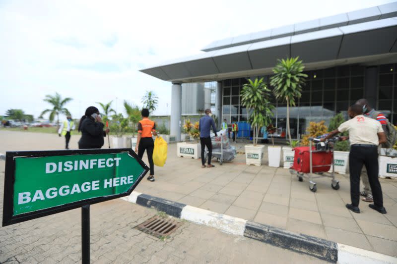 A disinfect baggage sign is pictured outside the Nnamdi Azikiwe International Airport in Abuja