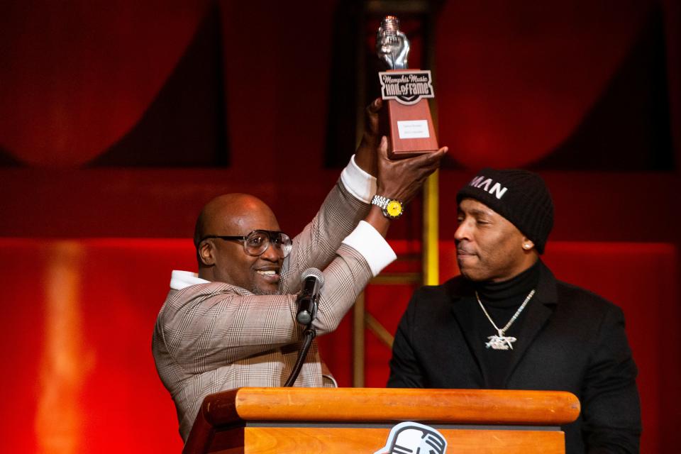 Carlos Broady holds up his “The Mic” trophy after being handed it by Drumma Boy while Broady is inducted into the Memphis Music Hall of Fame during the 2023 Induction Ceremony at the Cannon Center for the Performing Arts in Memphis, Tenn., on Thursday, October 12, 2023.