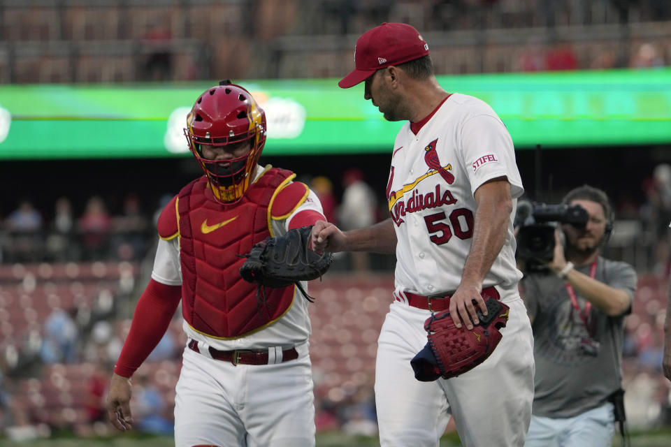 St. Louis Cardinals starting pitcher Adam Wainwright (50) gets a fist bump from catcher Willson Contreras as the head to the dugout after warming up before the start of a baseball game against the Milwaukee Brewers Monday, Sept. 18, 2023, in St. Louis. (AP Photo/Jeff Roberson)