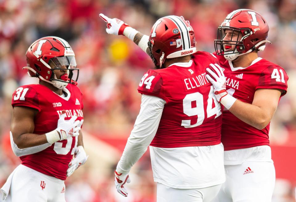 Indiana's Demarcus Elliott (94) and Beau Robbins (41) celebrate Elliott's sack during the first half of the Indiana versus Purdue football game at Memorial Stadium on Saturday, Nov. 26, 2022.