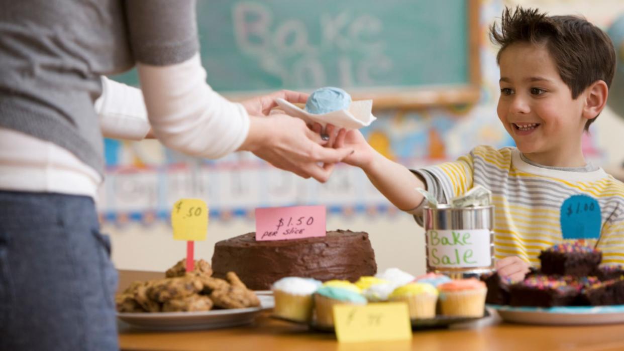  School fundraising ideas illustrated by boy on cake sale. 