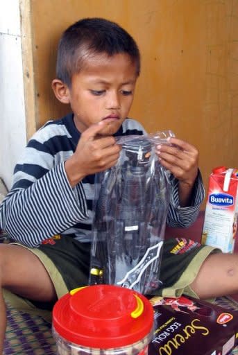 A photo provided by Komnas Perlingdungan shows Indonesian child Ilham playing at his home in Bogor last month. The eight-year-old, who smoked more than a pack of cigarettes a day from age four, has kicked the habit, a child-welfare commission said Thursday