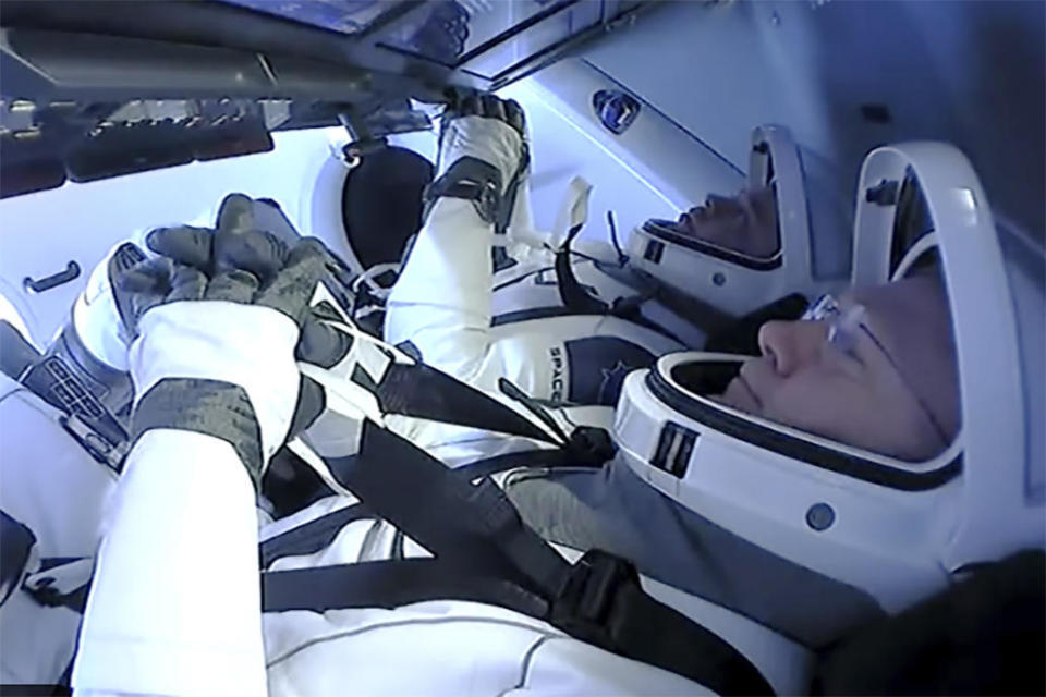 Doug Hurley, foreground, and Bob Behnken ready the Crew Dragon for reentry on Sunday. / Credit: NASA/SpaceX