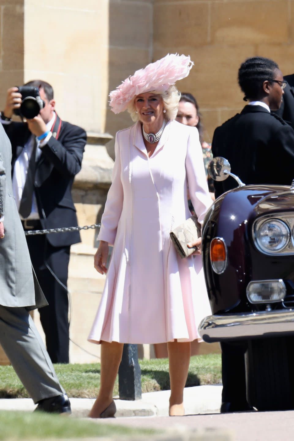 <p>Camilla stepped out in an ice pink silk coat dress by Anna Valentine and a stunning feathered <a href="https://www.townandcountrymag.com/style/fashion-trends/a20631716/camilla-parker-bowles-dress-hat-royal-wedding-2018/" rel="nofollow noopener" target="_blank" data-ylk="slk:Philip Treacy hat;elm:context_link;itc:0;sec:content-canvas" class="link ">Philip Treacy hat</a> at <a href="https://www.townandcountrymag.com/society/tradition/g14522381/prince-harry-meghan-markle-royal-wedding-2018-photos/" rel="nofollow noopener" target="_blank" data-ylk="slk:Prince Harry and Meghan Markle's wedding.;elm:context_link;itc:0;sec:content-canvas" class="link ">Prince Harry and Meghan Markle's wedding.</a></p>