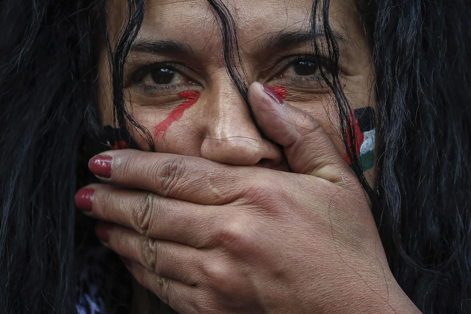 A protester takes part in a minutes silence during a demonstration organized by the "National Collective for a just and lasting peace between Palestinians and Israelis" in Paris, Sunday, Oct. 22, 2023. (AP Photo/Aurelien Morissard)