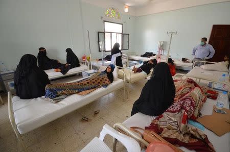 Women sit with relatives infected with cholera at a hospital in the Red Sea port city of Hodeidah, Yemen May 14, 2017. REUTERS/Abduljabbar Zeyad