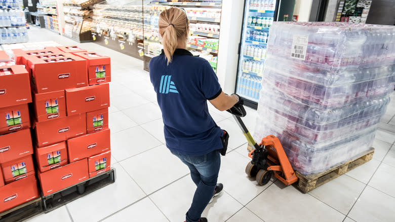 Aldi employee moving pallet