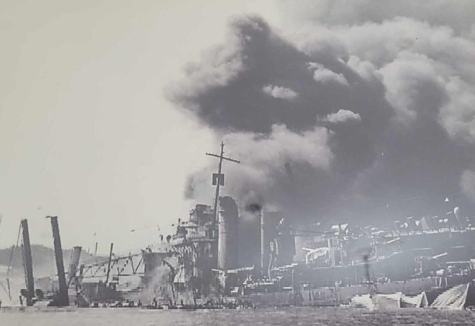 A photo of the attack on Pearl Harbor is in a frame along with the flag that's on display at the Historic Henderson County Courthouse. The flag flew on Dec. 7, 1941, at Pearl Harbor during the Japanese attack.