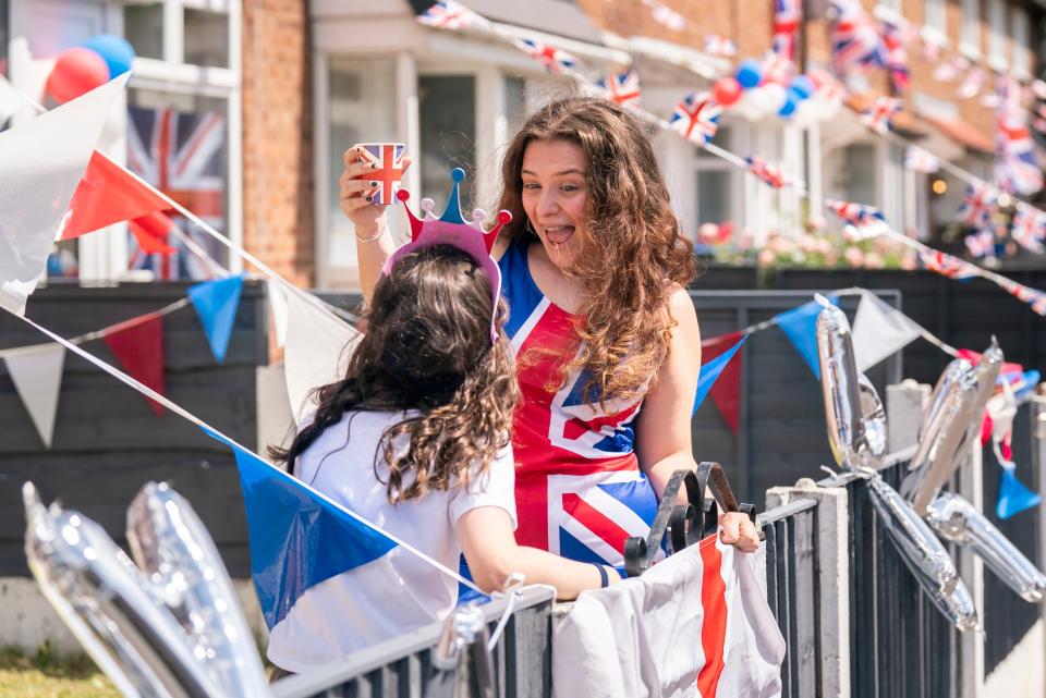 Jess Edge (right) celebrates with her sister Lucy Edge left) at a Jubilee Street Party in Trafford, Manchester, on day three of the Platinum Jubilee celebrations (PA)