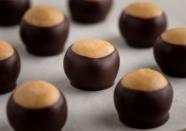 <p>Also known as the Buckeye State, Ohio is home to buckeyes, one of the <a href="https://www.thedailymeal.com/cook/13-swoon-worthy-chocolate-desserts-valentines-day-0?referrer=yahoo&category=beauty_food&include_utm=1&utm_medium=referral&utm_source=yahoo&utm_campaign=feed" rel="nofollow noopener" target="_blank" data-ylk="slk:the best treats for chocolate lovers;elm:context_link;itc:0;sec:content-canvas" class="link ">the best treats for chocolate lovers</a>. Buckeyes were named for their resemblance to the nuts that grow on a buckeye tree, which used to cover Ohio’s landscape. <a href="https://www.thedailymeal.com/best-recipes/buckeyes-recipe?referrer=yahoo&category=beauty_food&include_utm=1&utm_medium=referral&utm_source=yahoo&utm_campaign=feed" rel="nofollow noopener" target="_blank" data-ylk="slk:The candy is made;elm:context_link;itc:0;sec:content-canvas" class="link ">The candy is made</a> by mixing together peanut butter with butter and powdered sugar, rolling it into balls and dipping the mixture in sweet milk chocolate. You can find it at nearly any chocolate shop or grocery store in the state, so make sure you pick up a few. If you're really devoted, you can follow the <a href="https://www.homegrowngreat.com/tour/ohio-buckeye-candy-trail/?referrer=yahoo&category=beauty_food&include_utm=1&utm_medium=referral&utm_source=yahoo&utm_campaign=feed" rel="nofollow noopener" target="_blank" data-ylk="slk:Ohio Buckeye Candy Trail;elm:context_link;itc:0;sec:content-canvas" class="link ">Ohio Buckeye Candy Trail</a> to determine who makes the best for yourself.</p>