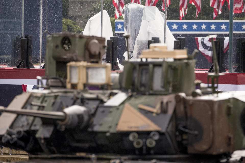 A Bradley Fighting Vehicle is visible in front of a podium covered up in the rain before President Donald Trump speaks at an Independence Day celebration in front of the Lincoln Memorial, Thursday, July 4, 2019, in Washington. (AP Photo/Andrew Harnik)