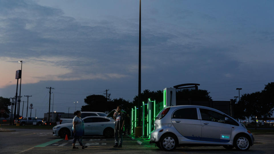 A couple wait on their EV to charge in Texas.