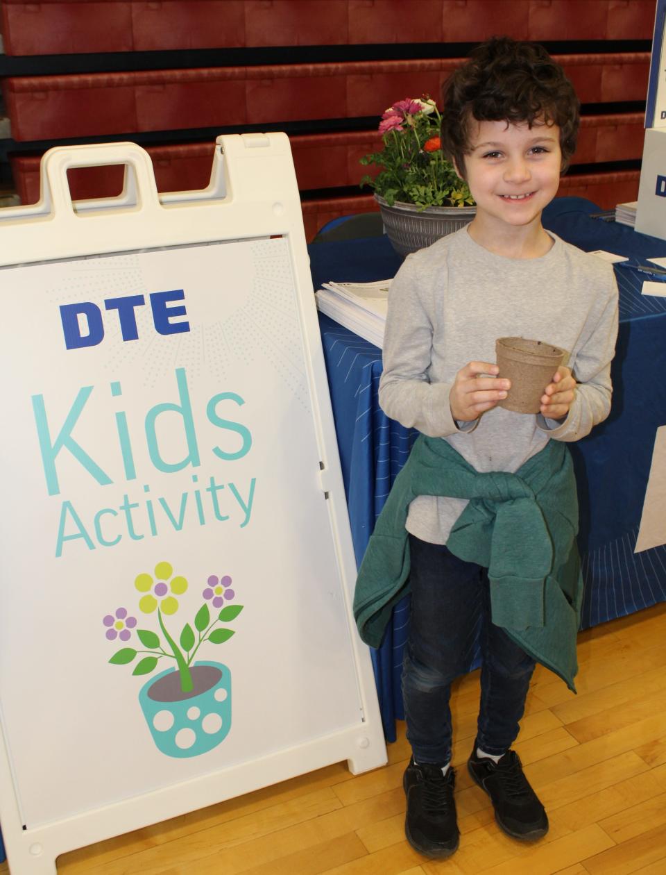 Sebastian Yates, then a first-grader at Manor Elementary School, potted pumpkin seeds to take home at a previous Earth Day Expo.