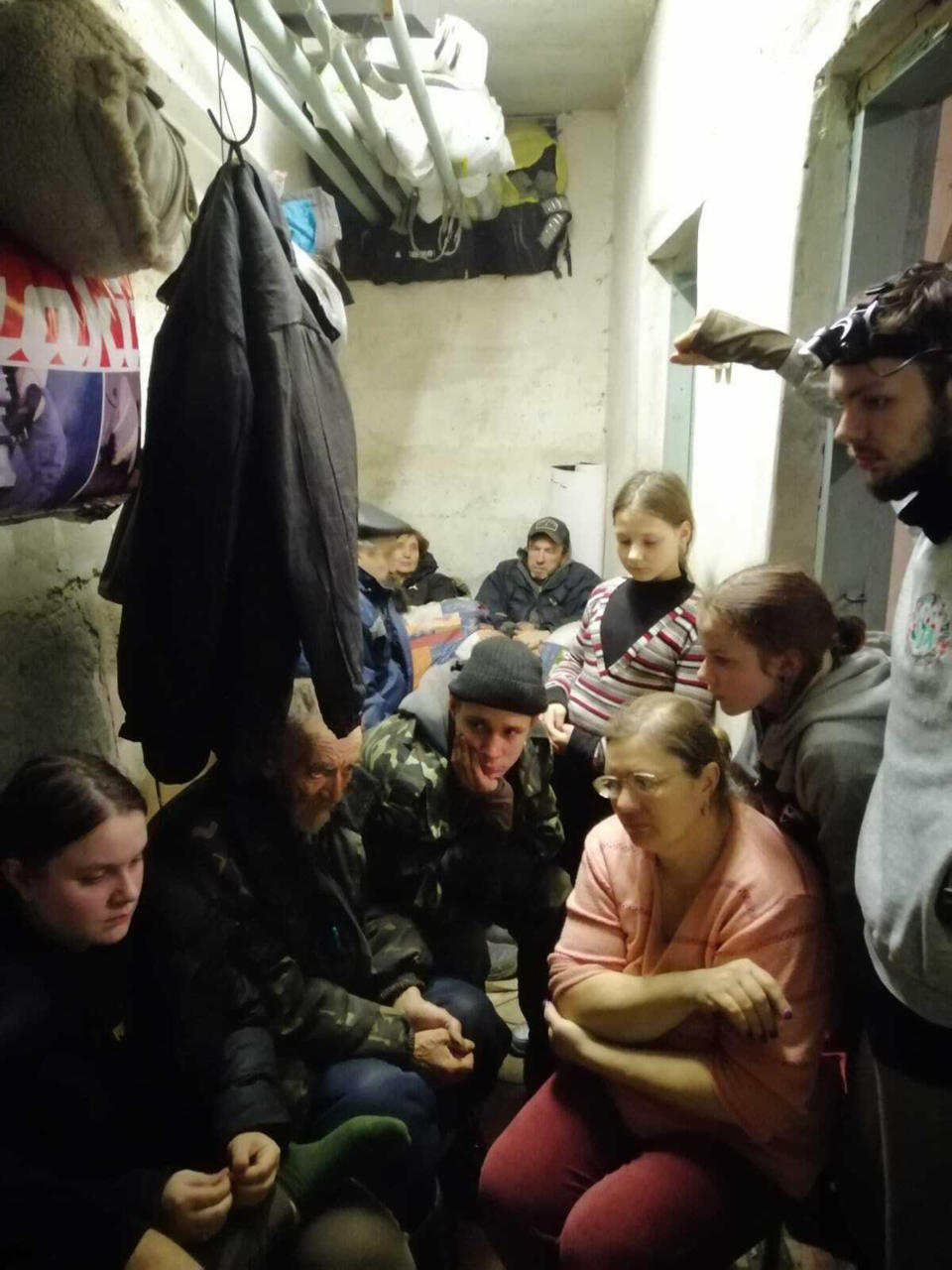 A family huddles together in the basement of the town's school. The citizens had to ration food and water in order to survive. At times, it was so hot they couldn't breathe.  (Courtesy Tetyana Diohtyar)