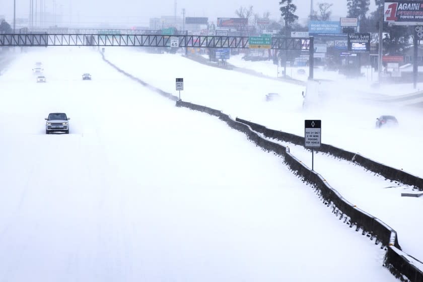 Traffic is sparse on the snow-covered I-45 near The Woodlands Parkway following an overnight snowfall Monday, Feb. 15, 2021 in The Woodlands, Texas. Temperatures plunged into the teens Monday with light snow and freezing rain. (Brett Coomer/Houston Chronicle via AP)