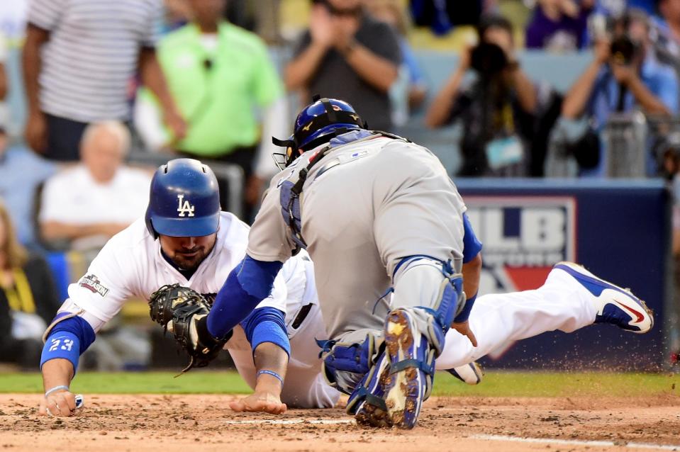 Adrian Gonzalez tries to reach past Willson Contreras. (Getty Images)