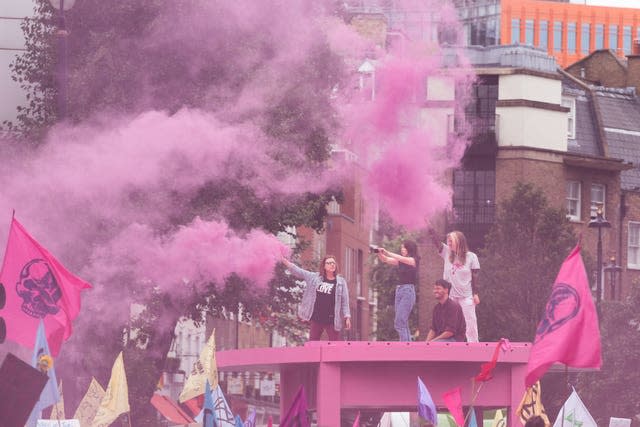 Protesters block the junction of Long Acre and Upper St Martin’s Lane with a large pink structure featuring the words “Come to the Table” (Stefan Rousseau/PA)