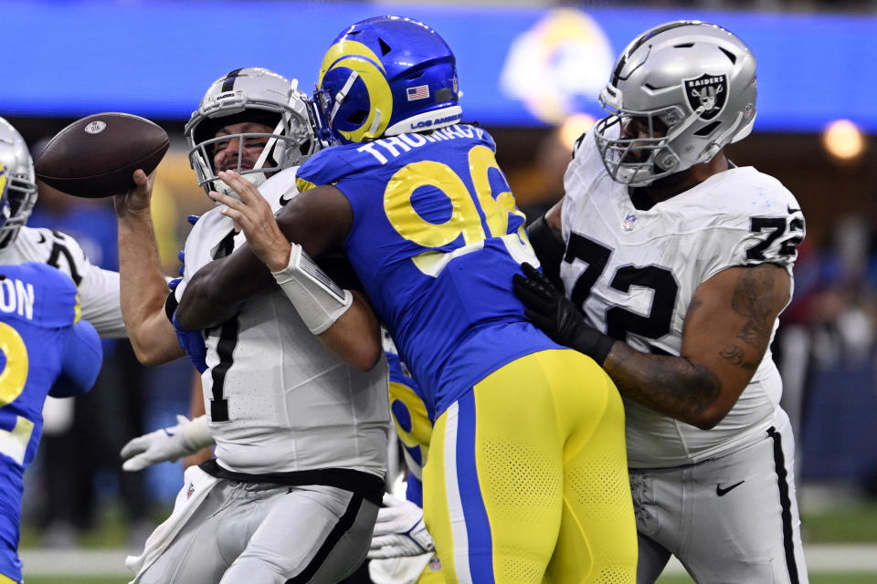 Las Vegas Raiders quarterback Brian Hoyer, left, is sacked by Los Angeles Rams linebacker Keir Thomas (96) during the first half of a preseason NFL football game Saturday, Aug. 19, 2023, in Inglewood, Calif. (AP Photo/Alex Gallardo)