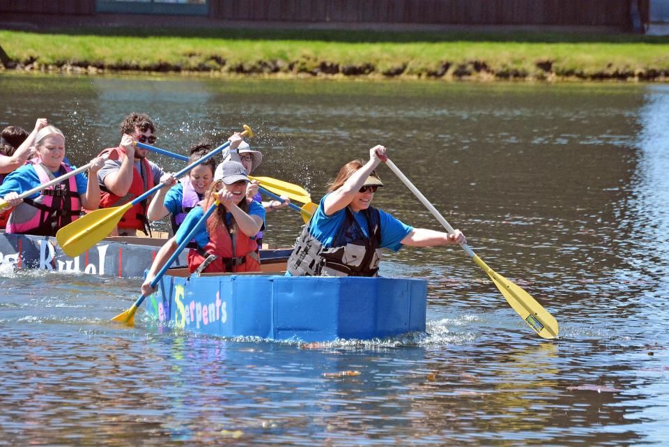 Cardboard boat teams the 'Sea Serpents' and 'Teachers Rule' start to race from the Bass Pro Shops lake in the annual Float Your Boat competition from the Food Bank for Central and Northeast Missouri.