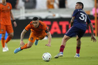 CORRECTS TO DYNAMO'S MATIAS VERA NOT MEMO RODRIGUEZ - Houston Dynamo's Matias Vera, left, is tripped by Chicago Fire's Federico Navarro (31) during the first half of an MLS soccer game Saturday, June 25, 2022, in Houston. (AP Photo/David J. Phillip)