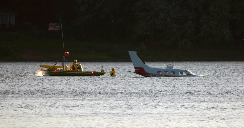 Emergency personnel secure a small plane that landed in in a shallow section of the Susquehanna River a few miles from the Three Mile Island nuclear power station, Friday, Oct. 4, 2019 near Middletown, Pa. Susquehanna Regional Airport Authority executive director Tim Edwards said the pilot and the single-engine plane's lone passenger were taken to a hospital for treatment. The Federal Aviation Administration says the two on board exited the Piper PA-46 onto a wing. (Garrett Doane/The Sun via AP)