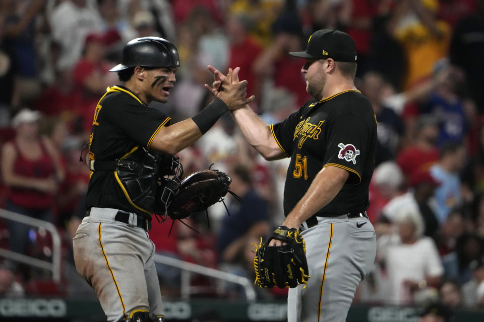 Pittsburgh Pirates catcher Endy Rodriguez, left, and relief pitcher David Bednar celebrate a 7-6 victory over the St. Louis Cardinals in a baseball game Saturday, Sept. 2, 2023, in St. Louis. (AP Photo/Jeff Roberson)