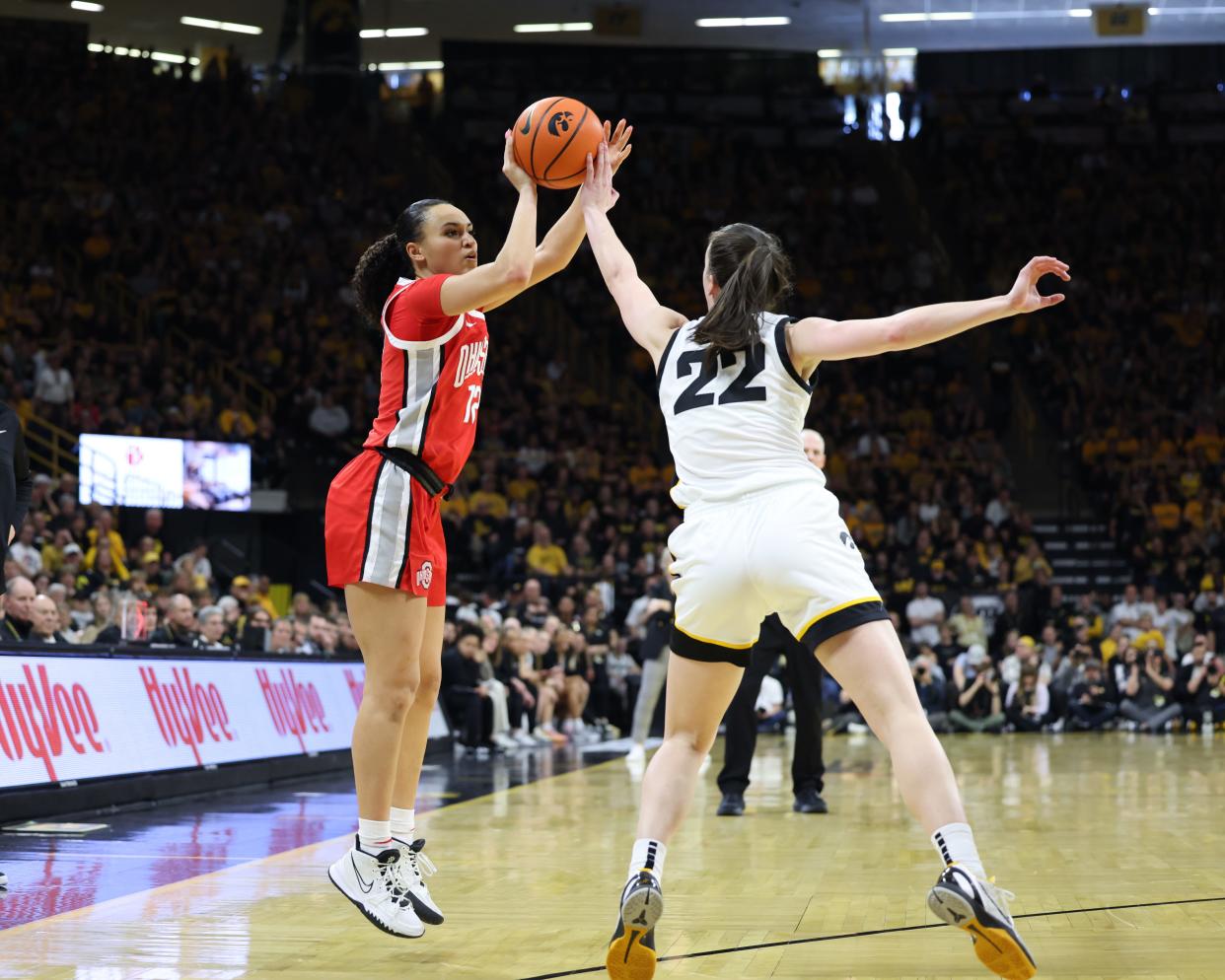 Mar 3, 2024; Iowa City, Iowa, USA; Iowa Hawkeyes guard Caitlin Clark (22) defends Ohio State Buckeyes guard Celeste Taylor (12) during the second half at Carver-Hawkeye Arena. Mandatory Credit: Reese Strickland-USA TODAY Sports