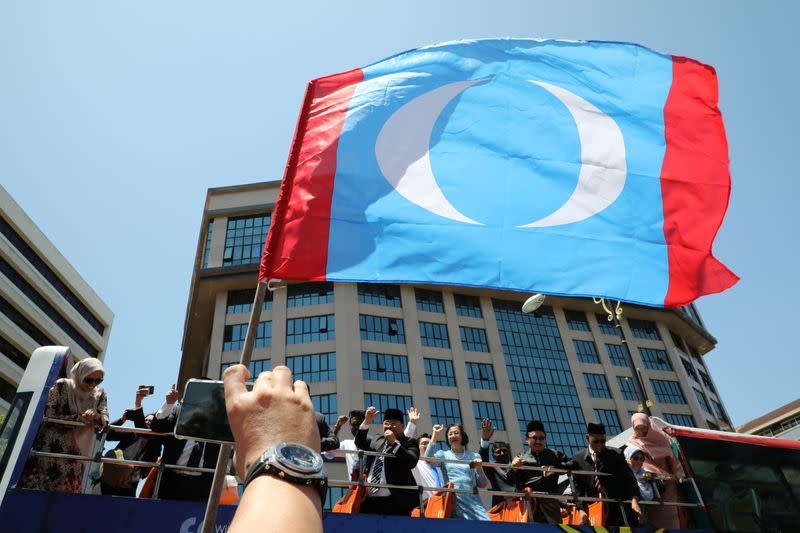 Malaysia's members of parliament from People's Justice Party wave to supporters after meeting with the King outside National Palace, Kuala Lumpur