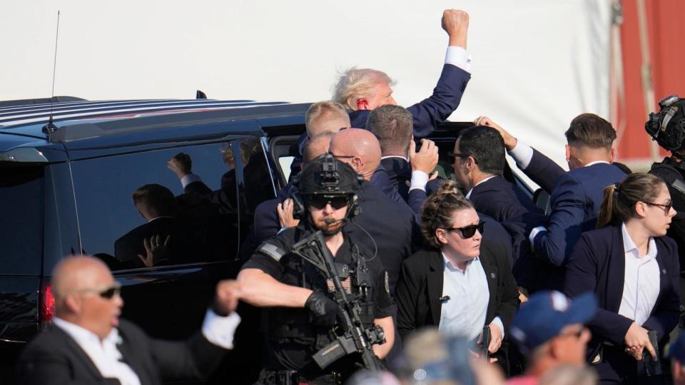 PHOTO: Republican presidential candidate former President Donald Trump pumps his fist as he is helped into a vehicle at a campaign event in Butler, Pa., on July 13, 2024.  (Gene J. Puskar/AP)