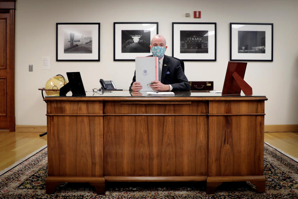 This photo provided by the New Jersey Governor's Office shows Gov. Phil Murphy as he has signed into law legislation to set up a recreational marijuana marketplace Monday, Feb. 22, 2021, in Trenton, N.J.