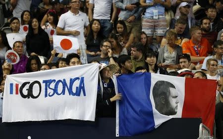 Fans of France's Jo-Wilfried Tsonga show their support during his fourth round match against Japan's Kei Nishikori at the Australian Open tennis tournament at Melbourne Park, Australia, January 24, 2016. REUTERS/Issei Kato