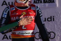 The winner Norway's Lucas Braathen celebrates on podium after an alpine ski, men's World Cup giant slalom, in Alta Badia, Italy, Sunday, Dec. 18, 2022. (AP Photo/Alessandro Trovati)