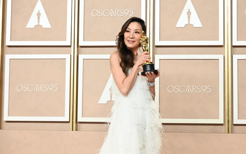 Yeoh celebrates her win in a white feathered Dior gown - Getty 