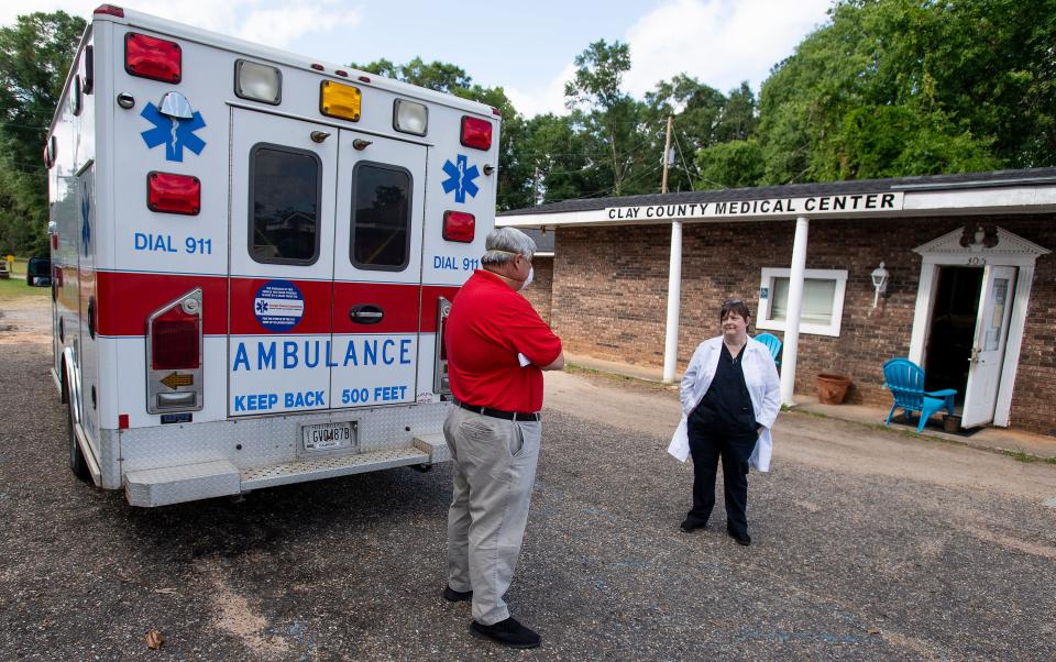 Dr. Karen Kinsell, right, chats with Wayne Royal, Director of Calhoun County EMS and 911 at her medical practice in Fort Gaines, Ga., on Thursday May 14, 2020.