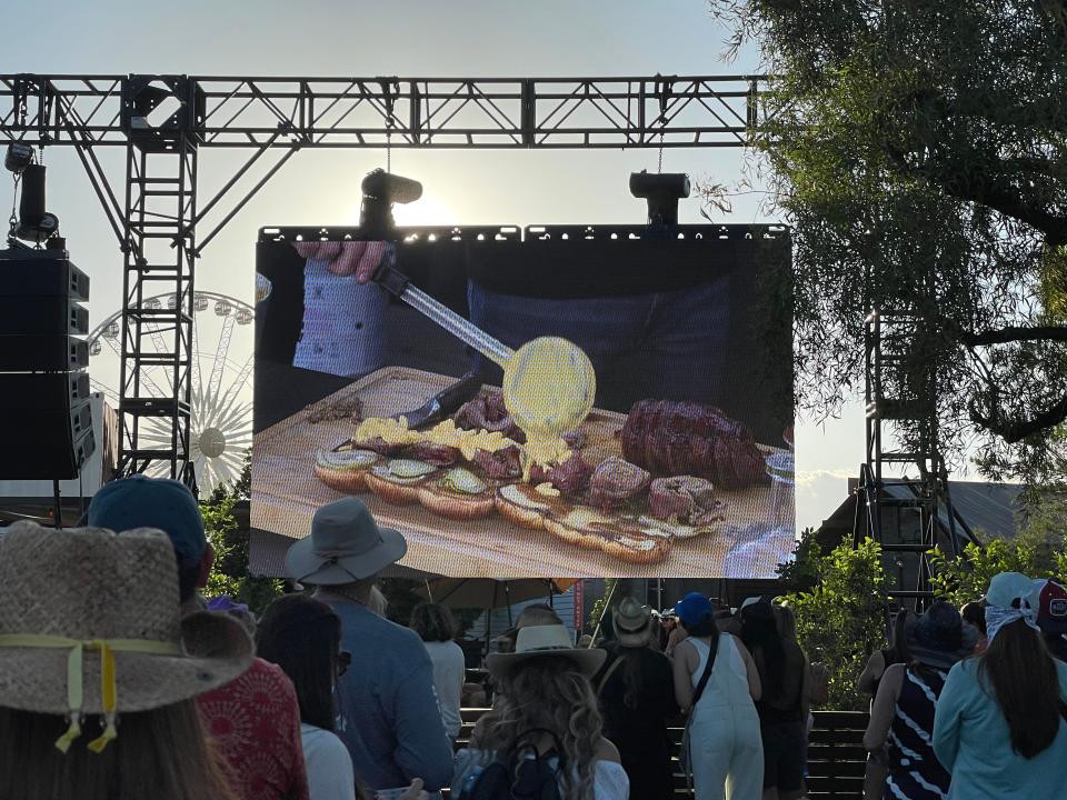 The Guy Fieri Smokehouse Cooking Demo whipped up a jelly roll, which consisted of a bacon-wrapped flank steak filled with pork sausage and veggies, topped with fried onions and macaroni and cheese and placed on a King's Hawaiian roll.