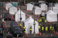 FILE - In this Feb. 16, 2021, file photo, motorists wait to get their COVID-19 vaccine at a federally-run vaccination site set up on the campus of California State University of Los Angeles, in Los Angeles. California is revamping a plan to help essential workers and seniors in underserved communities get coronavirus vaccinations after officials learned appointment access codes were leaked to people not eligible for the shots. The move comes as the state of 40 million people is striving to prioritize vaccinating the most vulnerable. (AP Photo/Jae C. Hong, File)