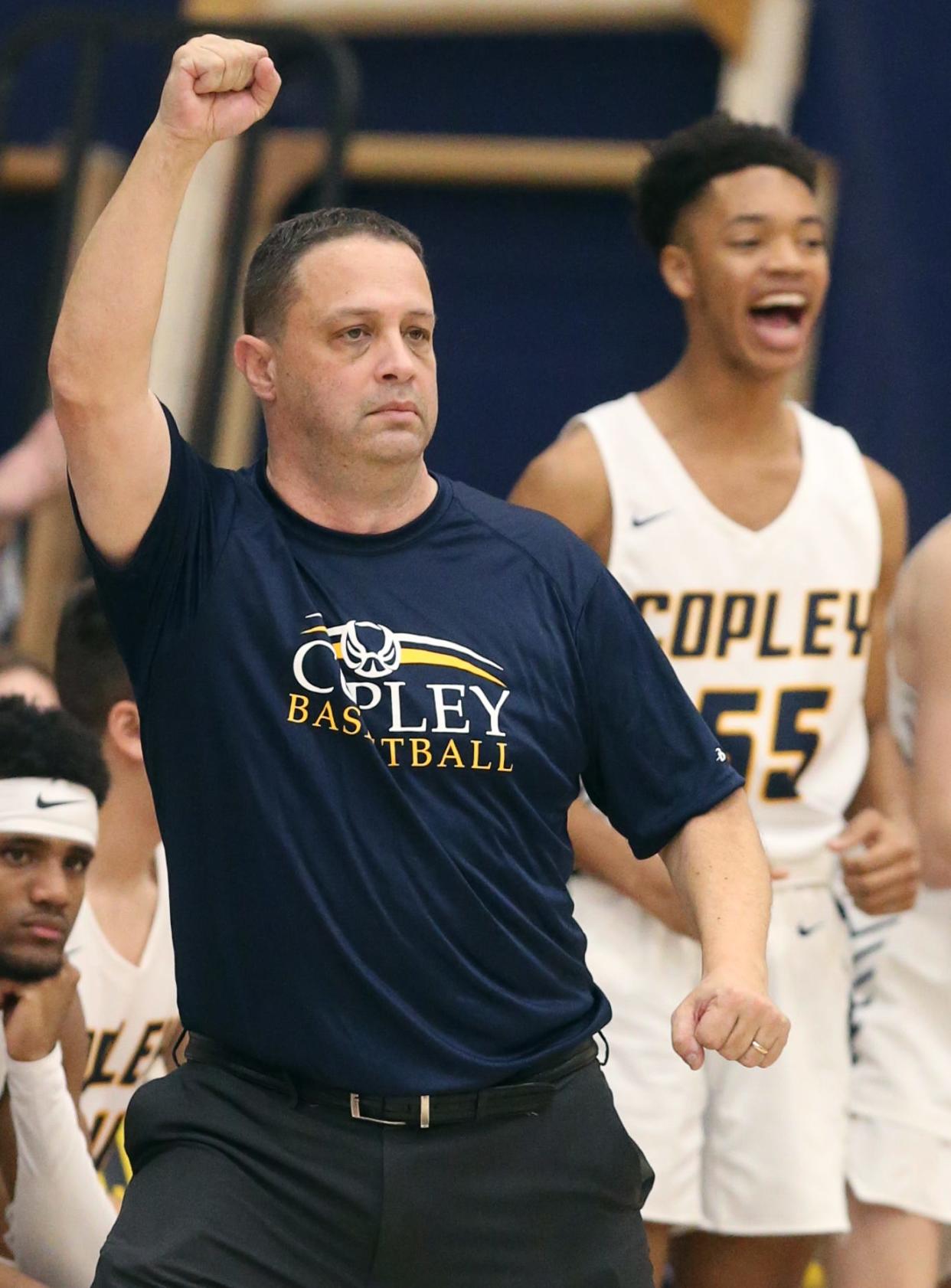 Copley basketball coach Mark Dente pumps his fist after a late fourth-quarter 3-point Indians basket Feb. 11 against Tallmadge.