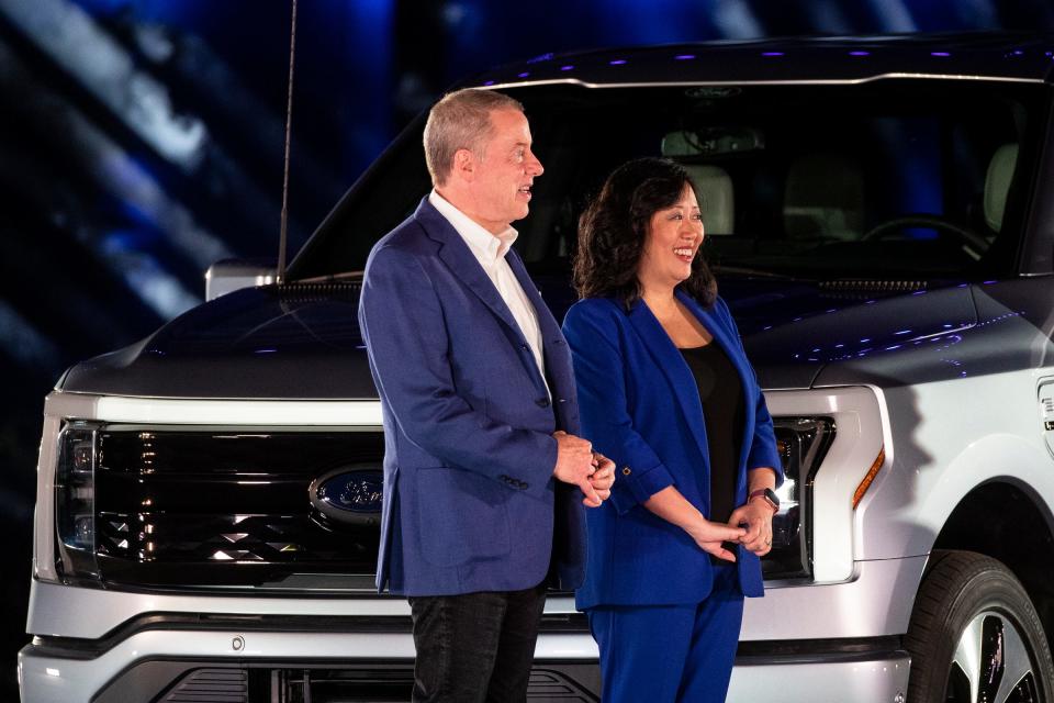 Bill Ford, executive chair of Ford Motor Co., stands next to Linda Zhang, chief engineer of the 2022 Ford F-150 Lightning, after Ford unveils the electric pickup truck at its world headquarters in Dearborn on May 19, 2021.