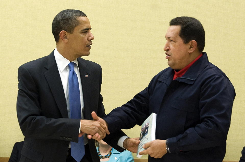 Venezuelan President Hugo Chavez (R) gives a book, <i>The Open Veins of Latin America</i>&nbsp;by Uruguayan writer Eduardo Galeano to U.S. President Barack Obama during a multilateral meeting to begin during the Summit of the Americas at the Hyatt Regency in Port of Spain, Trinidad, April 18, 2009.